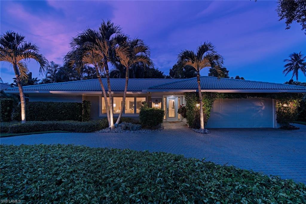 691 Ketch Drive Naples, FL 34103 - Photo 14 of 16 a view of a porch and a yard