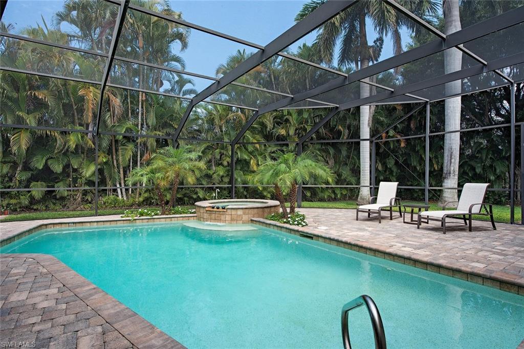691 Ketch Drive Naples, FL 34103 - Photo 2 of 16 a view of a swimming pool with a patio and a yard