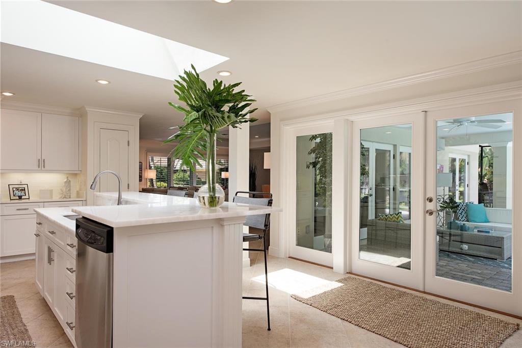 691 Ketch Drive Naples, FL 34103 - Photo 7 of 16 a kitchen with a sink and cabinets