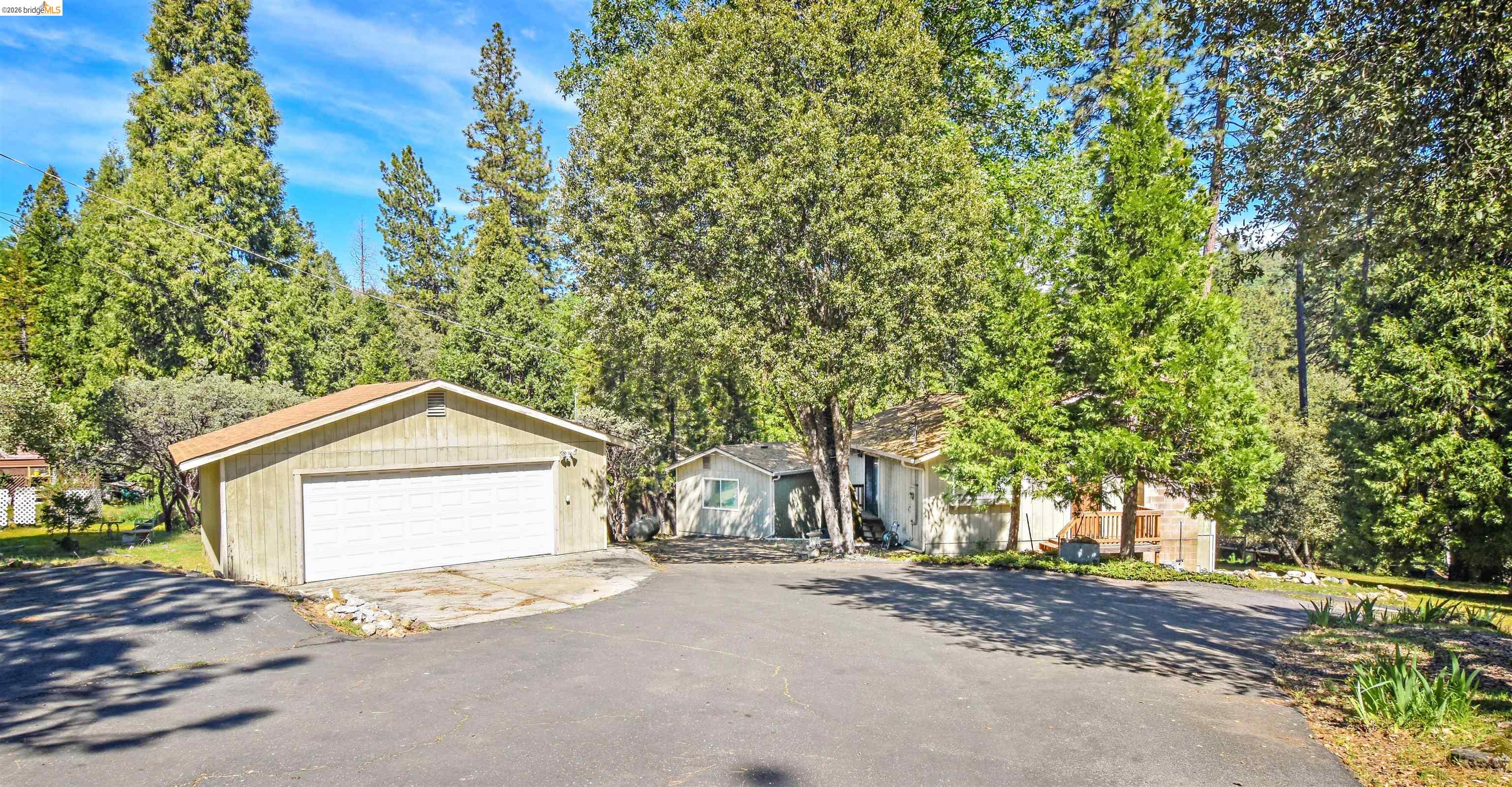 21881 Phoenix Lake Road Sonora, CA 95370 - Photo 1 of 1 a view of a house with a tree and a yard