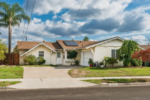 a front view of house with yard and green space