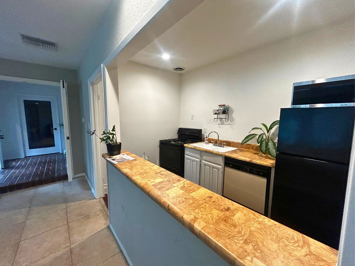 8210 Bent Tree Road, Unit 247 Austin, TX 78759 - Photo 21 of 21 a kitchen with granite countertop a refrigerator and a stove
