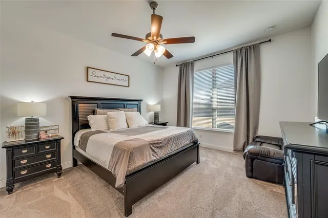 a spacious bedroom with a bed and a chandelier