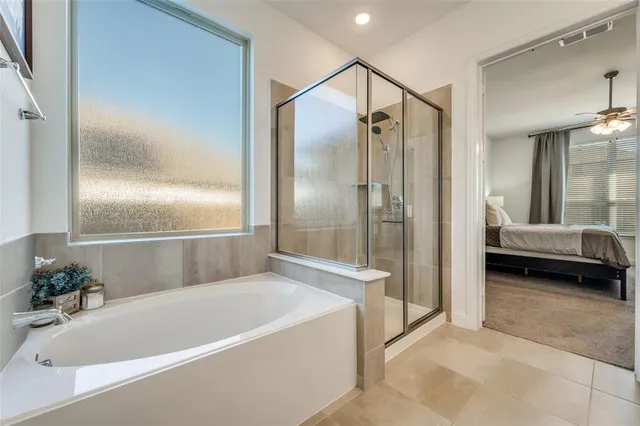 a bathroom with a tub and shower