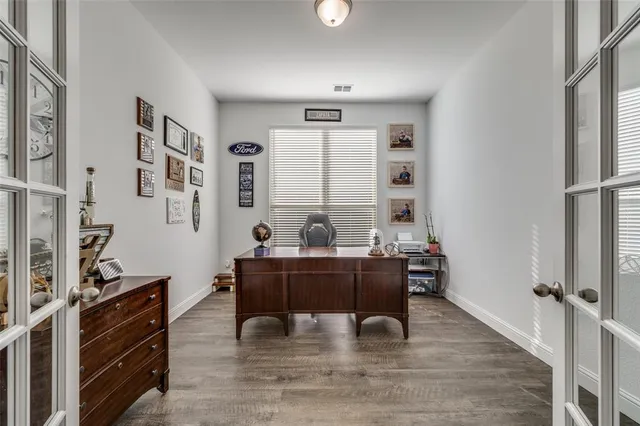 a view of a workspace with furniture and a window