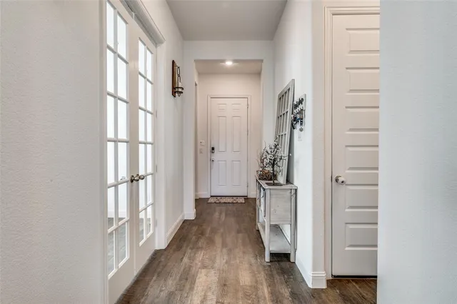a view of a hallway with wooden floor and staircase