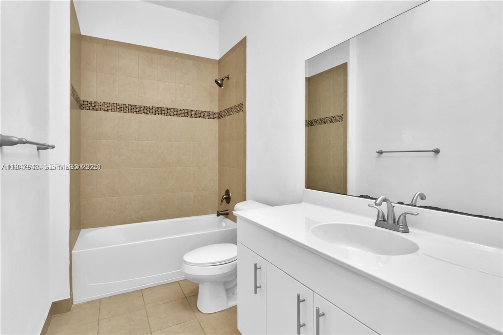 673 Northeast 191st Street Miami, FL 33179 - Photo 14 of 25 a bathroom with a sink toilet and shower