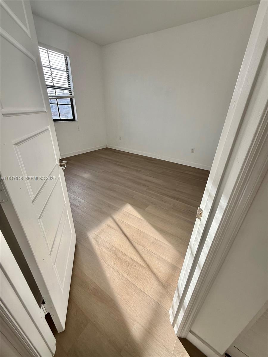673 Northeast 191st Street Miami, FL 33179 - Photo 17 of 25 a view of staircase with white walls and window