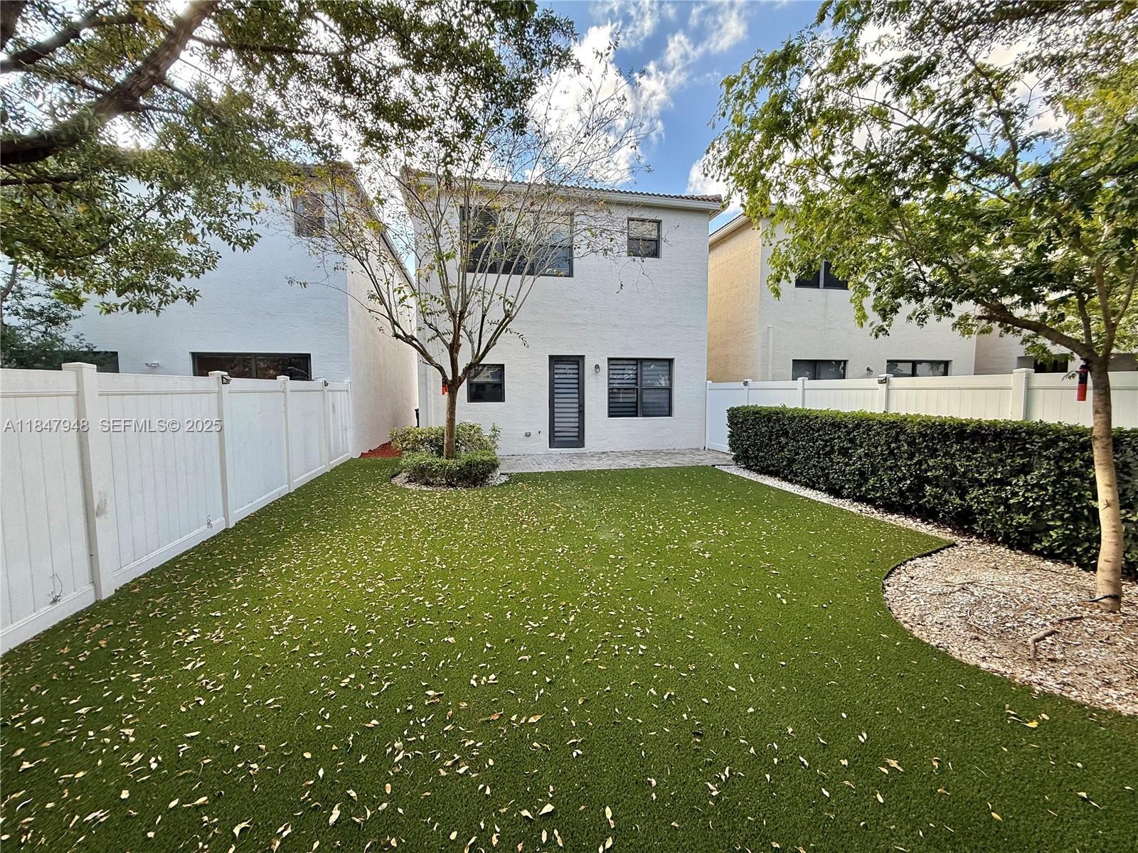 673 Northeast 191st Street Miami, FL 33179 - Photo 24 of 25 a view of a house with a backyard