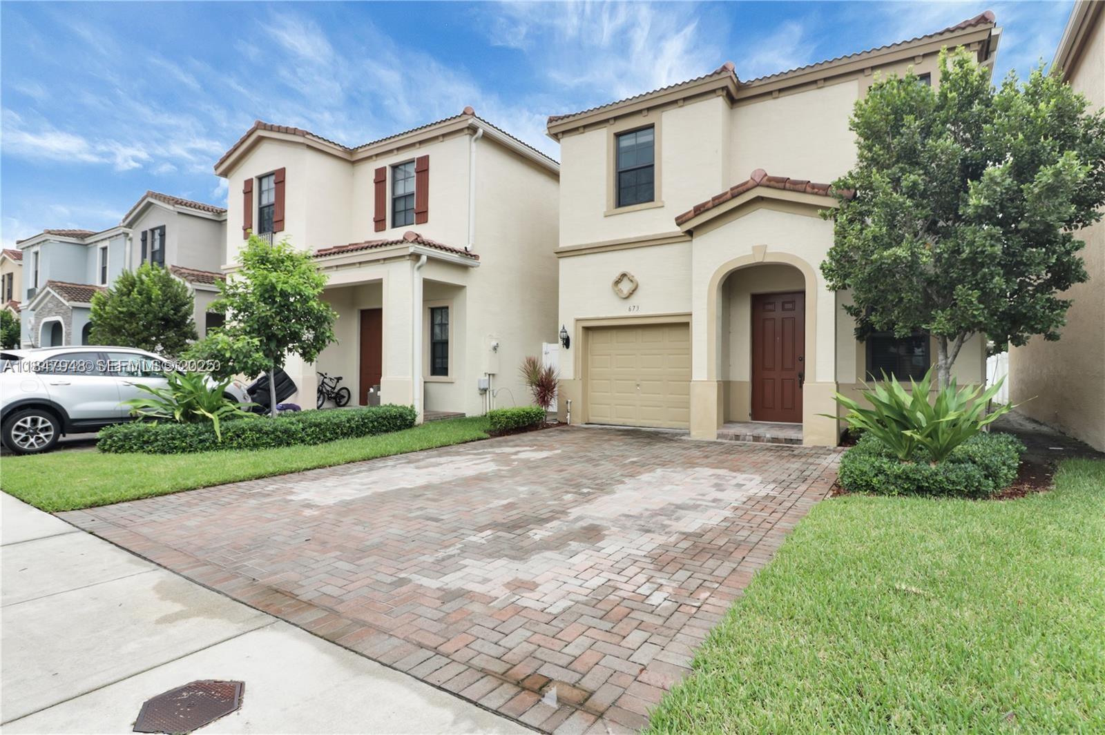673 Northeast 191st Street Miami, FL 33179 - Photo 3 of 25 a view of outdoor space yard and front view of a house