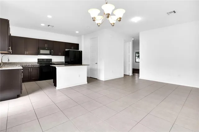 a view of a kitchen with microwave and windows