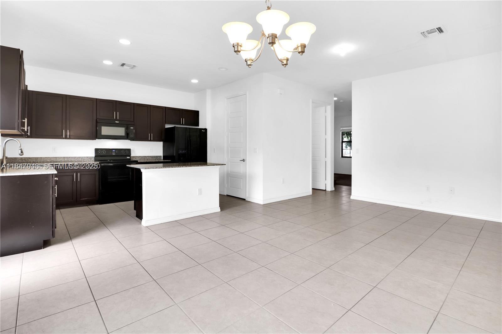 673 Northeast 191st Street Miami, FL 33179 - Photo 9 of 25 a view of kitchen with stainless steel appliances granite countertop a refrigerator a sink dishwasher and a stove