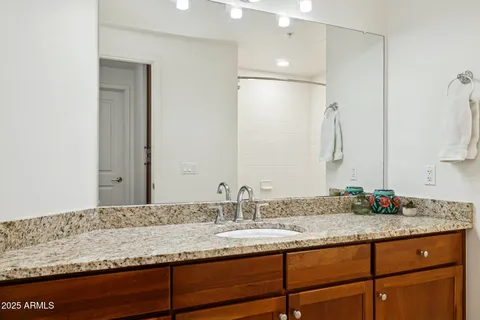 an empty room with wooden floor cabinet and windows