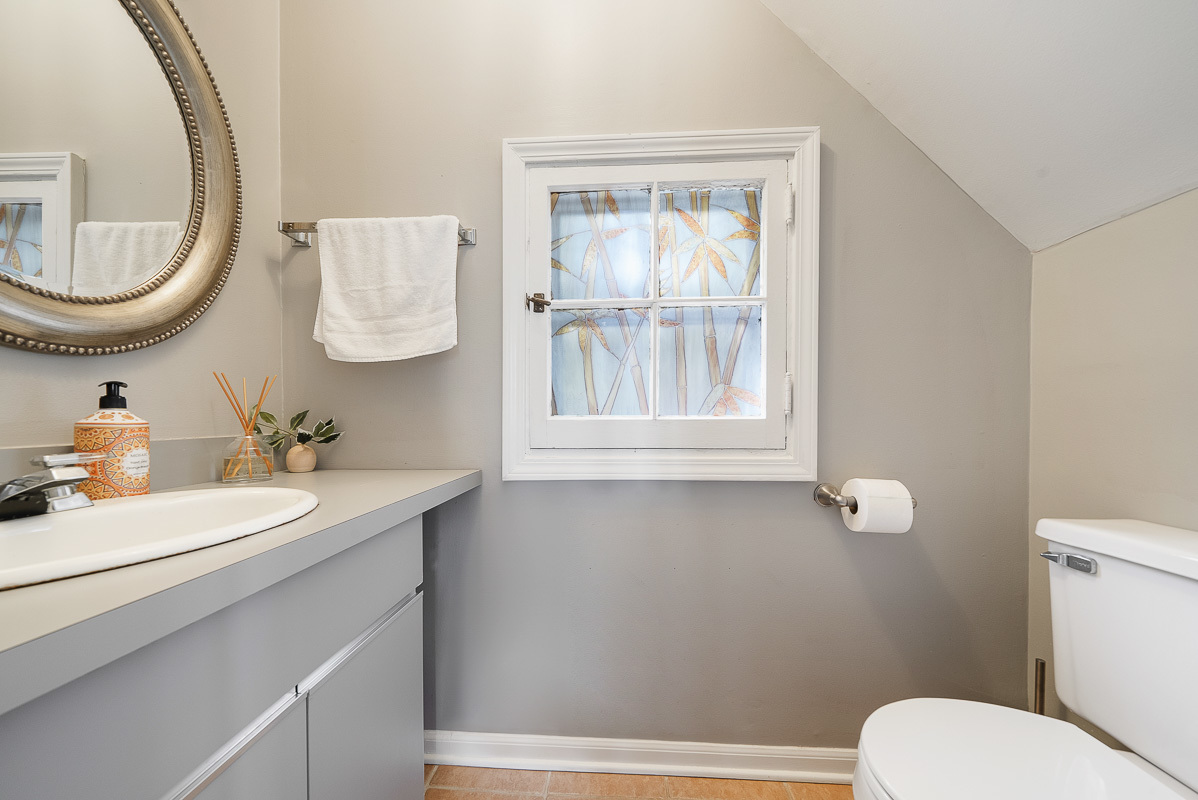 515 Maple Avenue Wilmette, IL 60091 - Photo 9 of 24 a bathroom with a toilet sink a mirror and a window