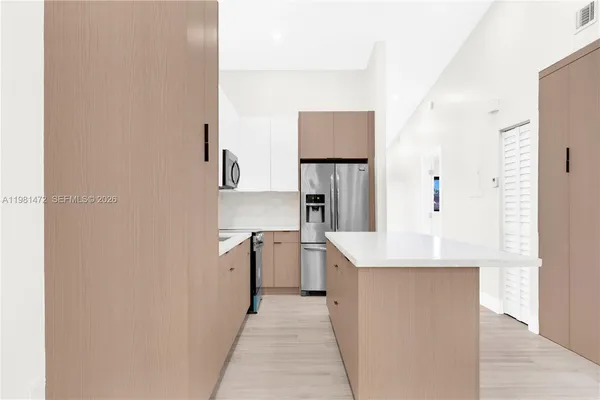 a kitchen with a sink dishwasher stove and refrigerator