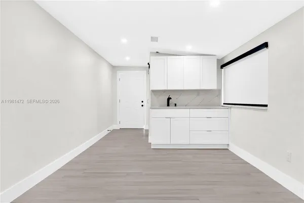a view of kitchen with wooden floor