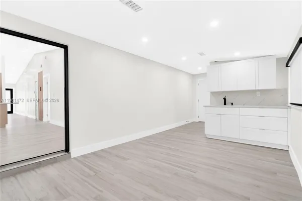 a view of kitchen with wooden floor and window