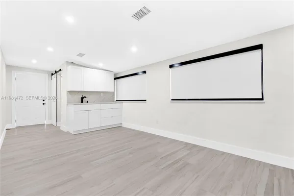 a view of a kitchen with wooden floor