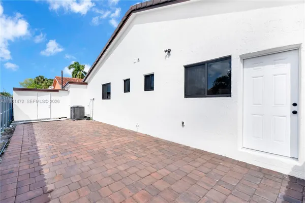 a view of a white house with a yard and garage