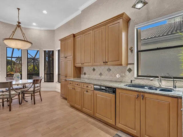 a kitchen with stainless steel appliances granite countertop a sink and cabinets