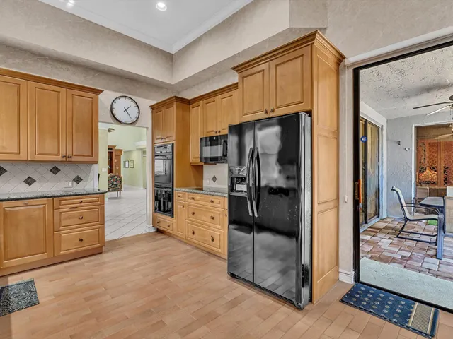 a kitchen with stainless steel appliances a refrigerator and cabinets
