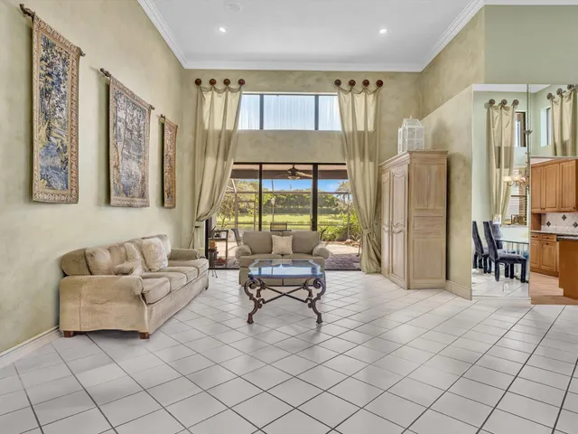 a living room with furniture and large windows