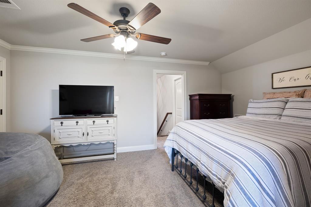 2103 Cash Point Court Granbury, TX 76049 - Photo 26 of 38 a bedroom with a bed and a flat screen tv