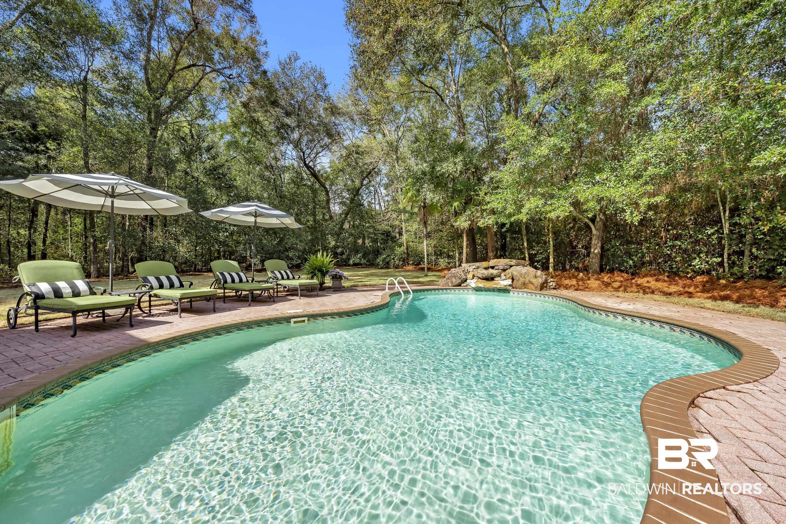 12161 Jessamine Street Magnolia Springs, AL 36555 - Photo 52 of 70 Outdoor pool featuring a patio area and view of wooded area