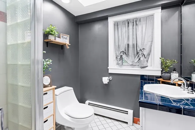 a living room with furniture a rug and a window