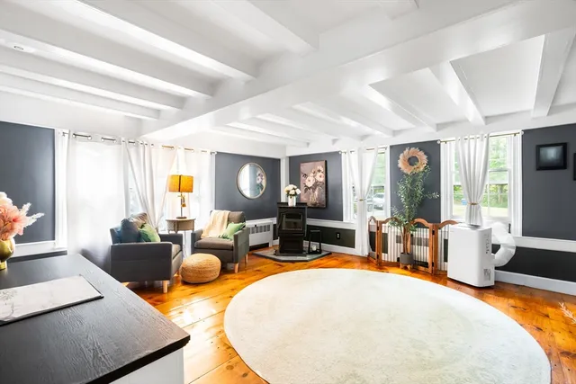 a living room with furniture a fireplace and a window