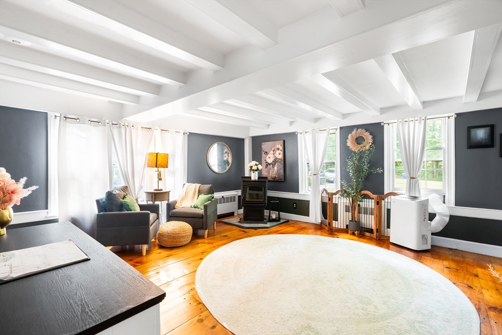 756 Northfield Road Lunenburg, MA 01462 - Photo 14 of 38 a living room with furniture a large window and dining table