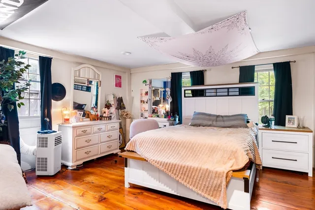 a bedroom with a bed and window