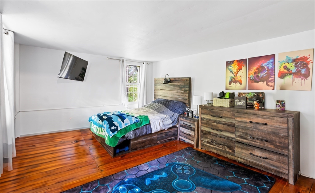 756 Northfield Road Lunenburg, MA 01462 - Photo 23 of 38 a living room with furniture and a flat screen tv