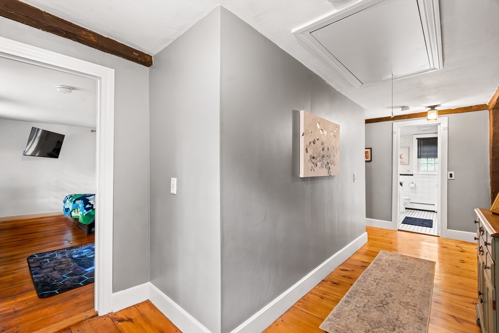 756 Northfield Road Lunenburg, MA 01462 - Photo 25 of 38 a hallway with a couch and dresser