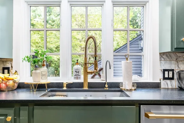 a kitchen with stainless steel appliances granite countertop a sink refrigerator and microwave