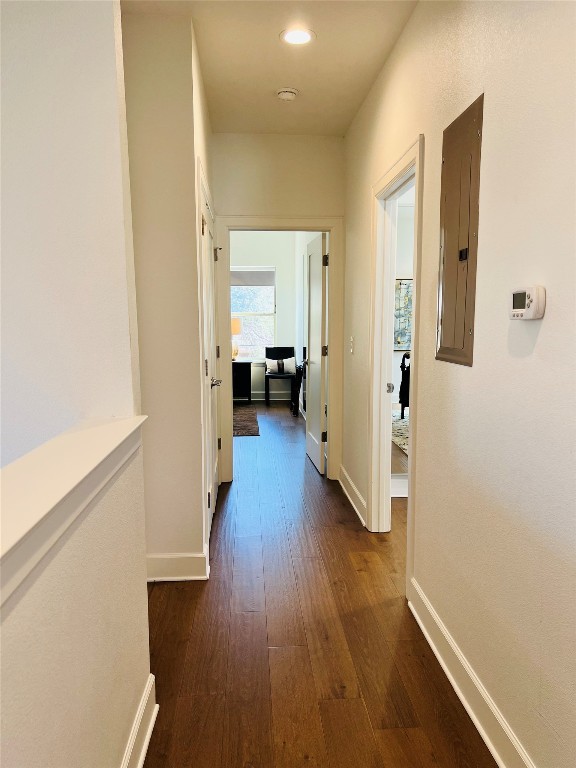 4704 Duval Street Austin, TX 78751 - Photo 25 of 29 Hall featuring dark wood-style floors, electric panel, and baseboards