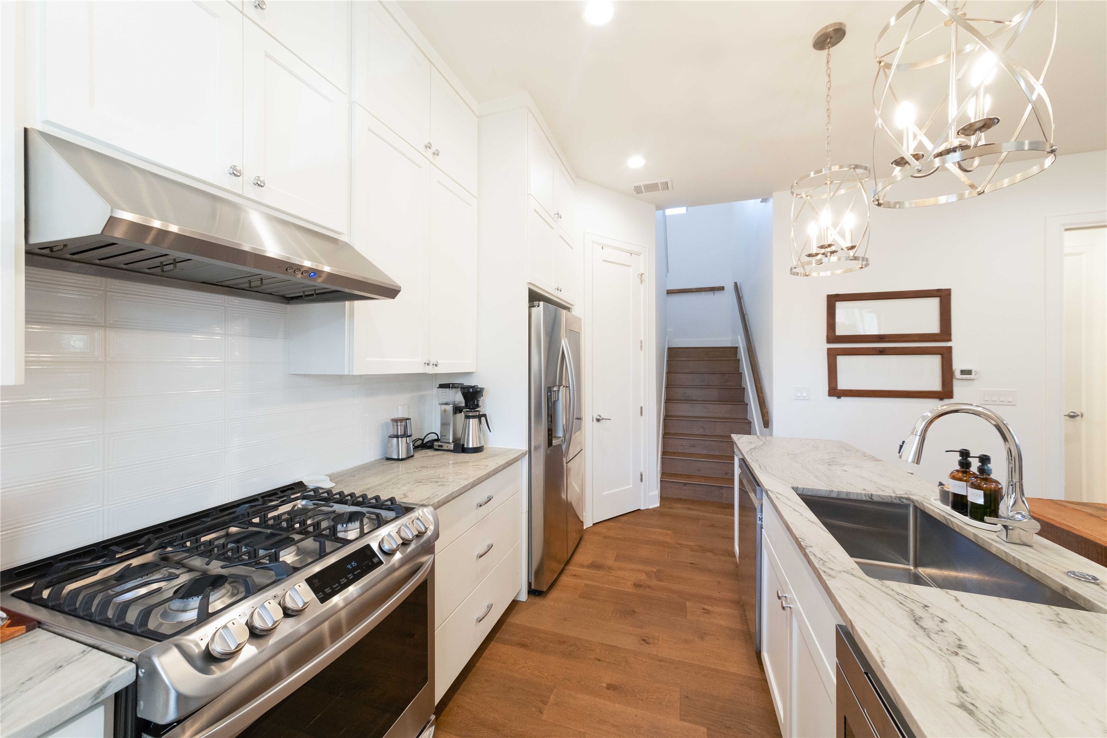 4704 Duval Street Austin, TX 78751 - Photo 9 of 29 a kitchen with granite countertop a stove and a sink