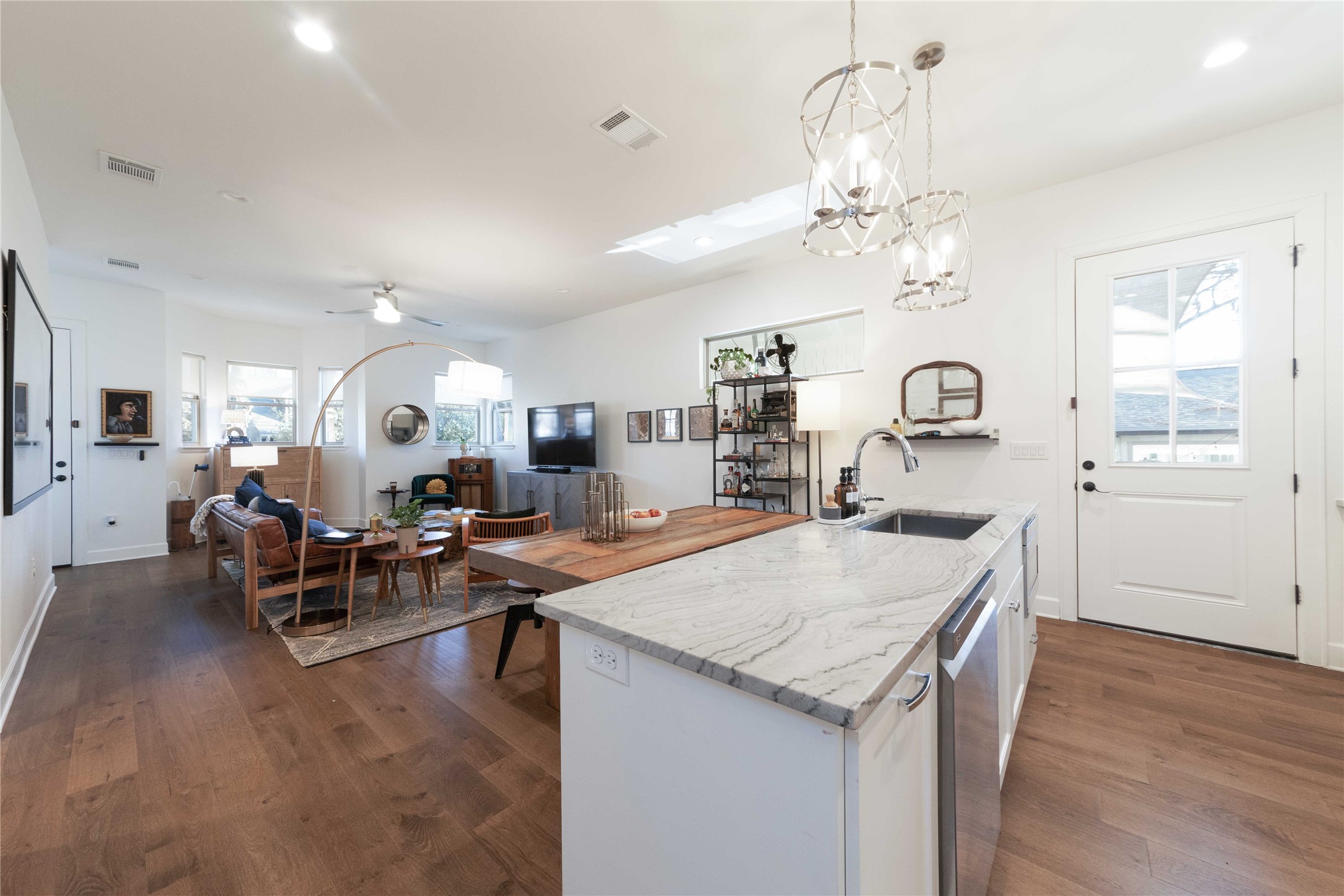 4704 Duval Street Austin, TX 78751 - Photo 10 of 29 a living room with kitchen island furniture and a chandelier