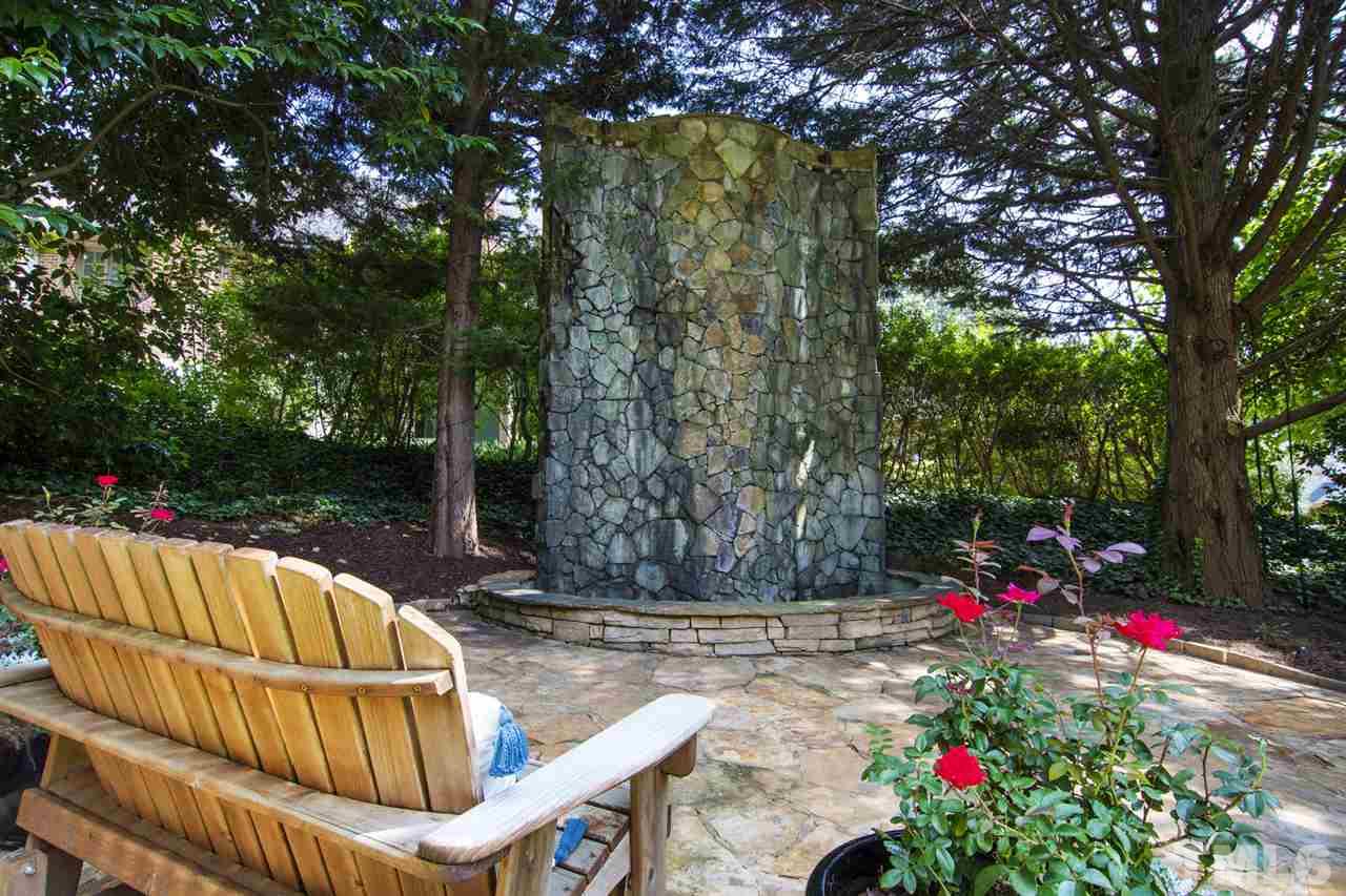 1806 Ridge Road Raleigh, NC 27607 - Photo 28 of 30 Soothing sounds come from this decorative waterfall...a perfect backdrop for summer evenings. Don't miss the firepit nook off to the side yard and the trellised walkway along the other. Outdoor living is gracious at 1806 Ridge Rd.