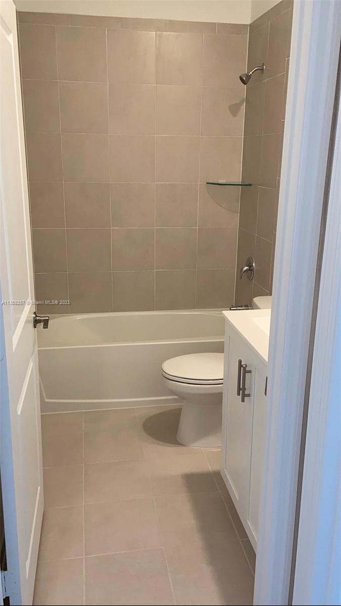 18107 Southwest 147th Court Miami, FL 33196 - Photo 11 of 25 a bathroom with a toilet and a shower