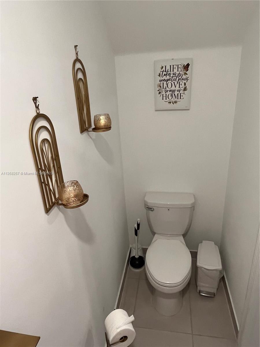 18107 Southwest 147th Court Miami, FL 33196 - Photo 12 of 25 a white toilet sitting next to a bathroom