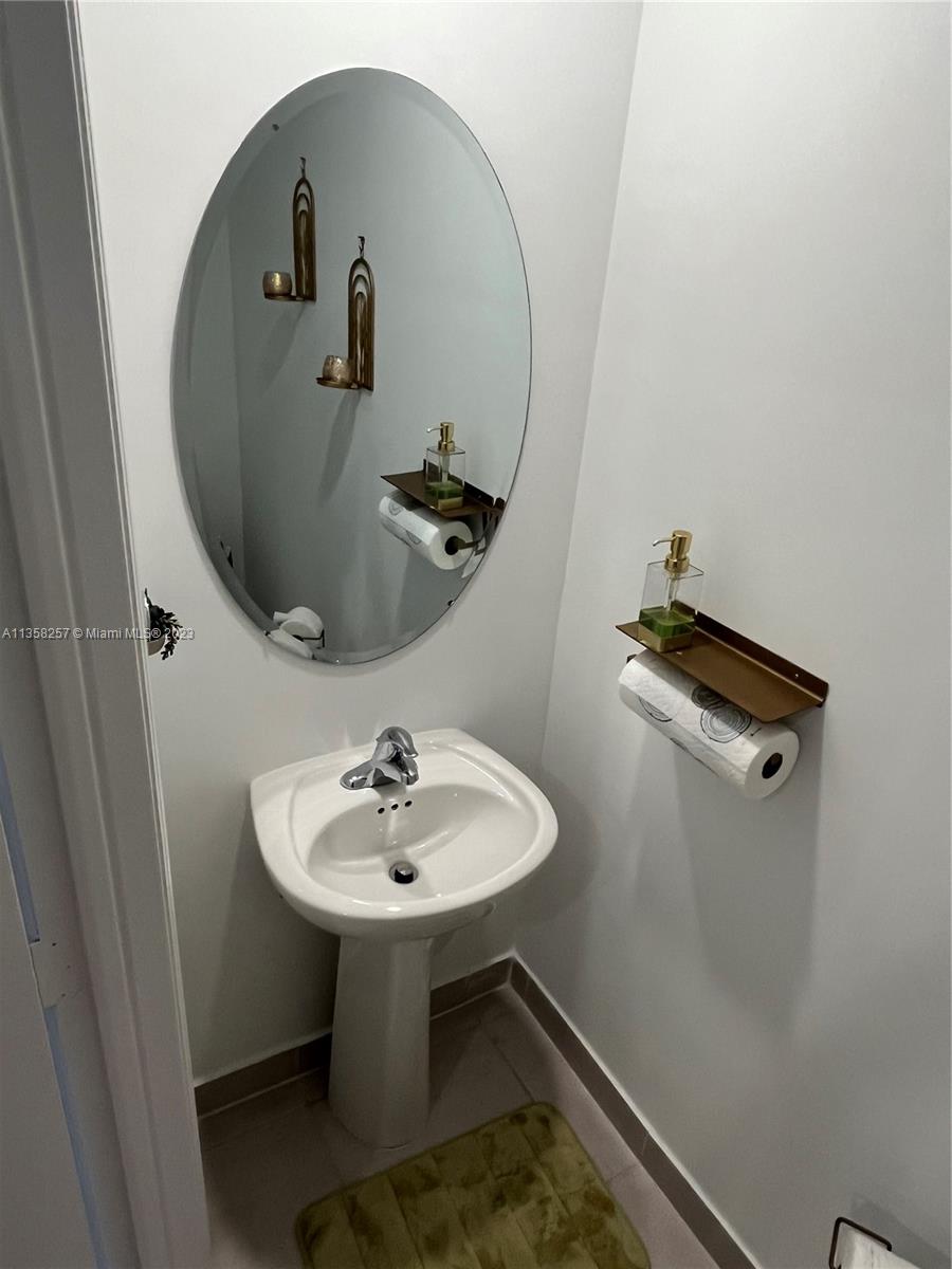 18107 Southwest 147th Court Miami, FL 33196 - Photo 13 of 25 a bathroom with a sink and mirror