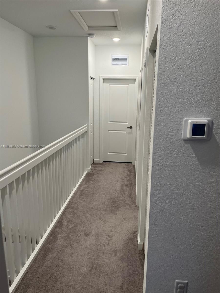 18107 Southwest 147th Court Miami, FL 33196 - Photo 18 of 25 a view of a hallway