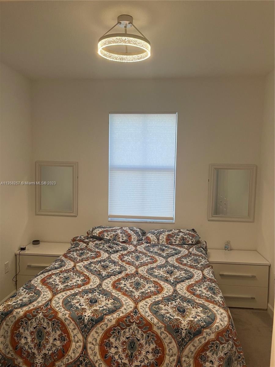 18107 Southwest 147th Court Miami, FL 33196 - Photo 19 of 25 a bedroom with a bed and a window