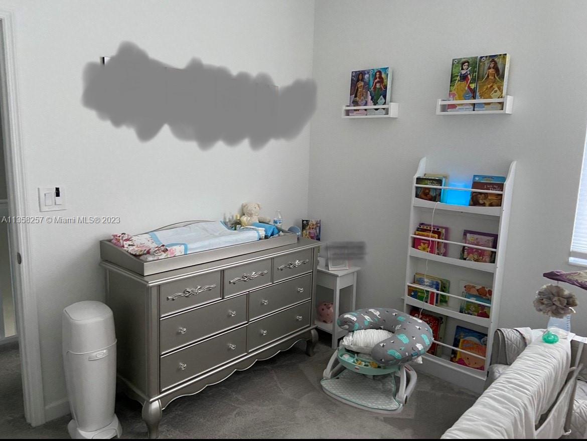 18107 Southwest 147th Court Miami, FL 33196 - Photo 21 of 25 a room with furniture and a shelf