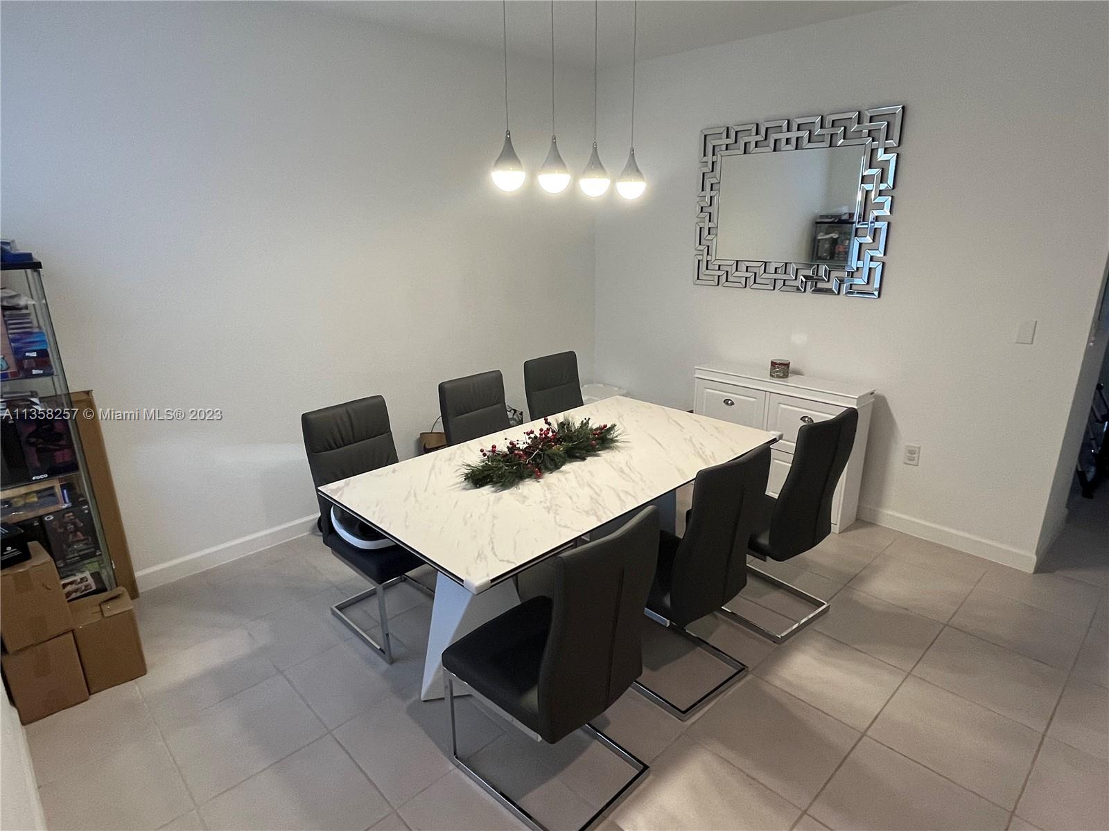 18107 Southwest 147th Court Miami, FL 33196 - Photo 7 of 25 a view of a dining table and chairs