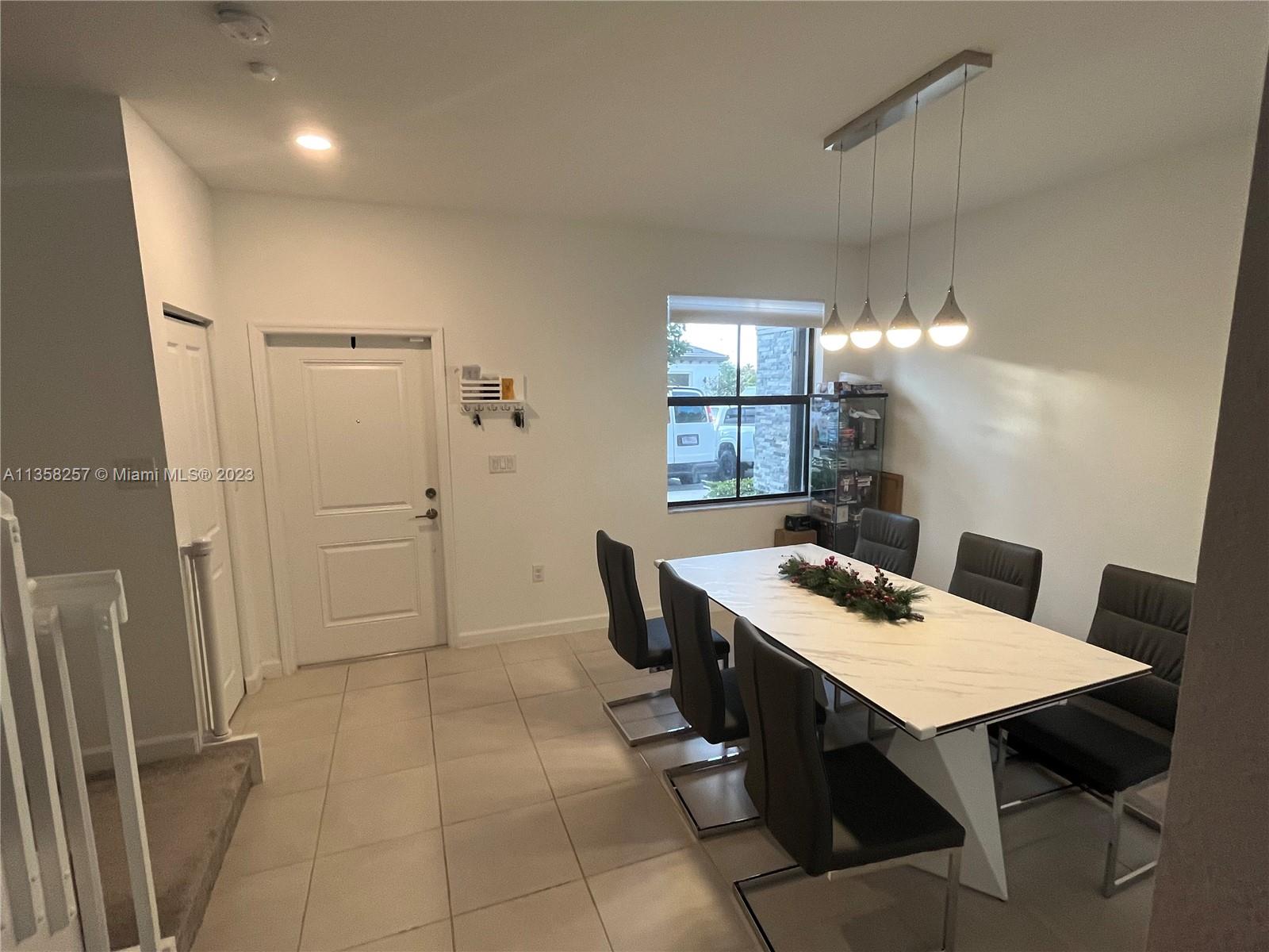 18107 Southwest 147th Court Miami, FL 33196 - Photo 8 of 25 a view of a dining room with furniture