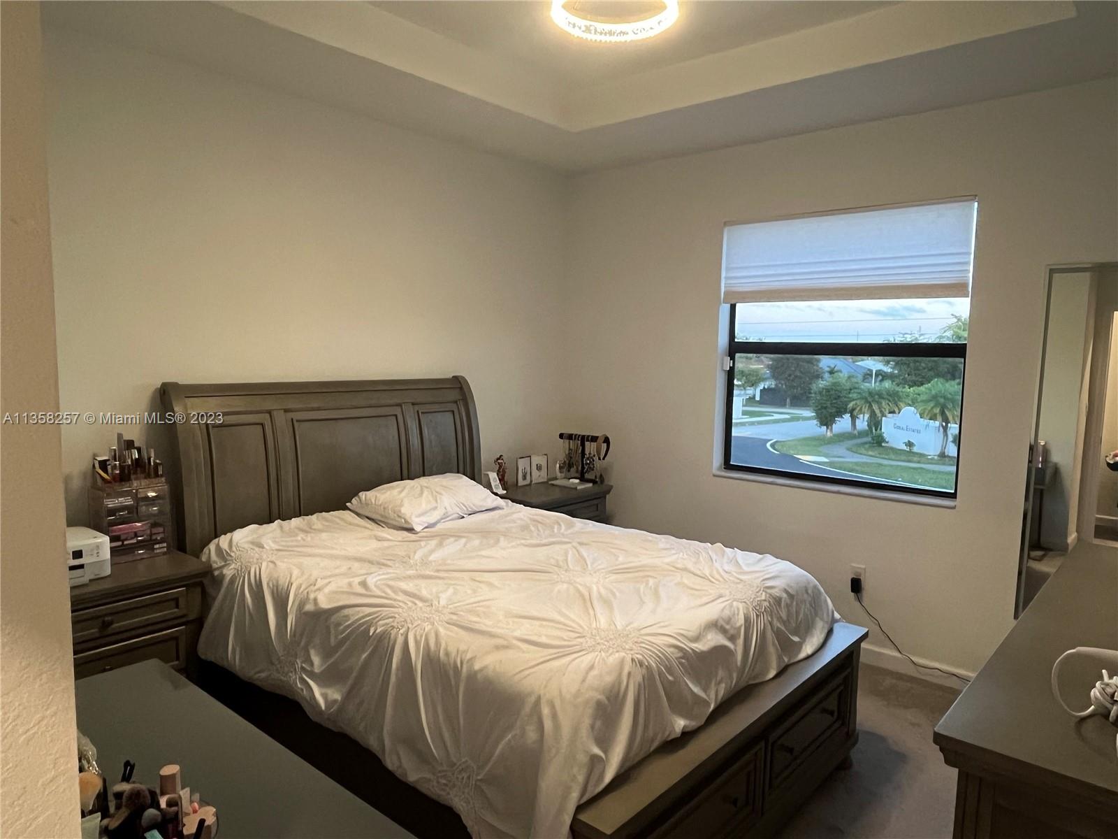 18107 Southwest 147th Court Miami, FL 33196 - Photo 9 of 25 a bedroom with a bed and a painting on the wall