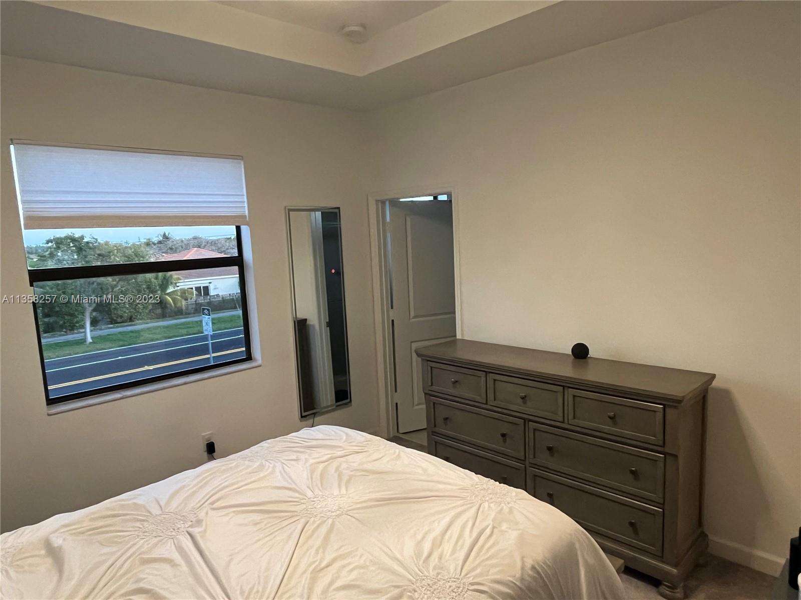 18107 Southwest 147th Court Miami, FL 33196 - Photo 10 of 25 a bedroom with a bed and a dresser