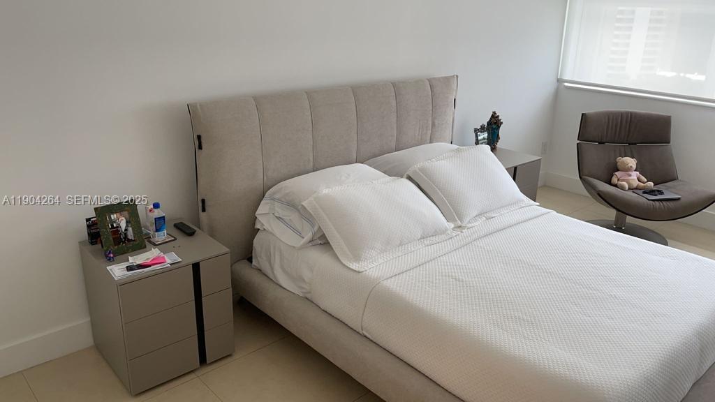 1420 Brickell Bay Drive, Unit 1406D Miami, FL 33131 - Photo 8 of 23 a bedroom with a bed and a tv on the dresser